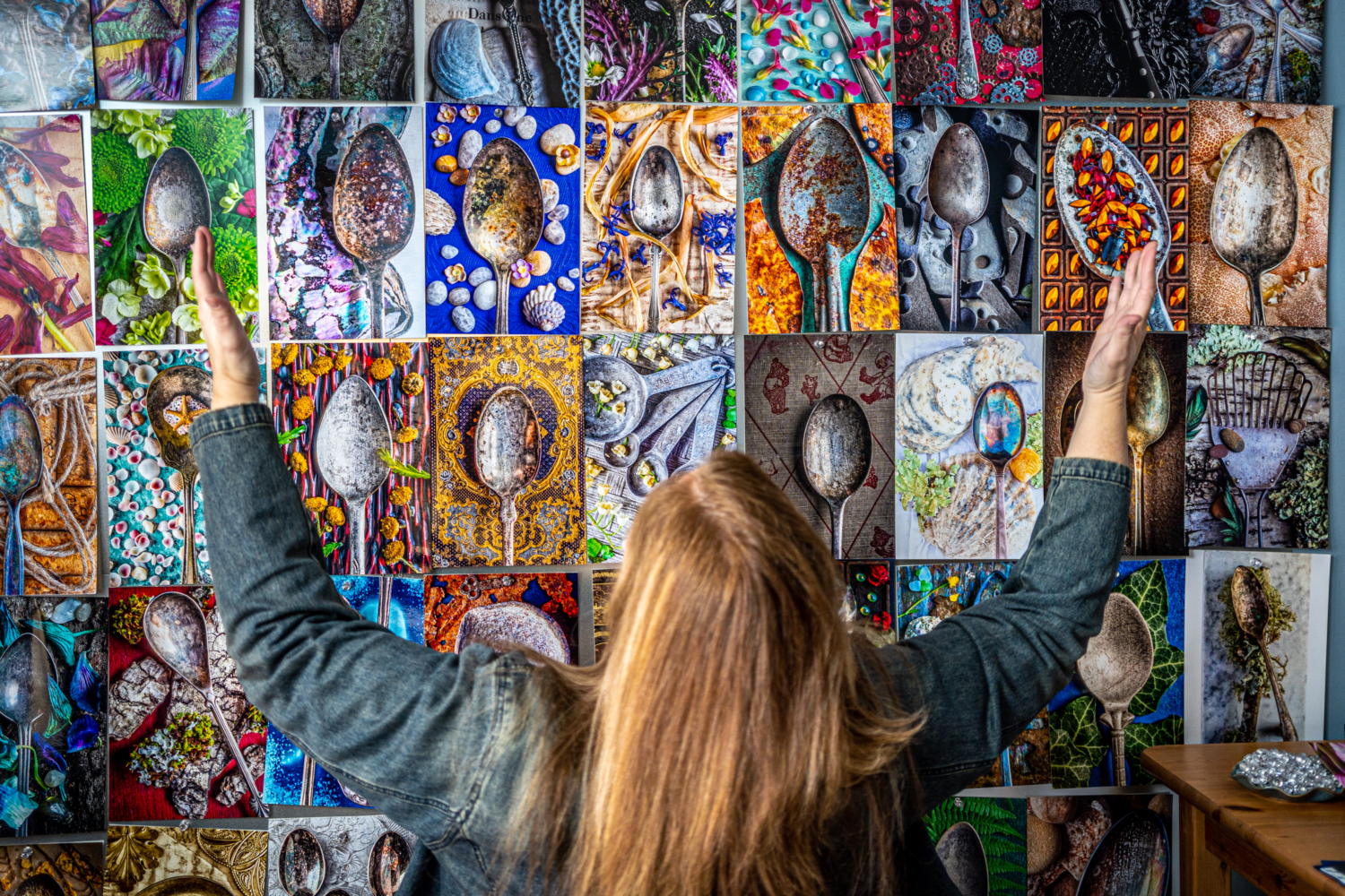 Donna Dufault in front of a wall of her worn spoon photographs