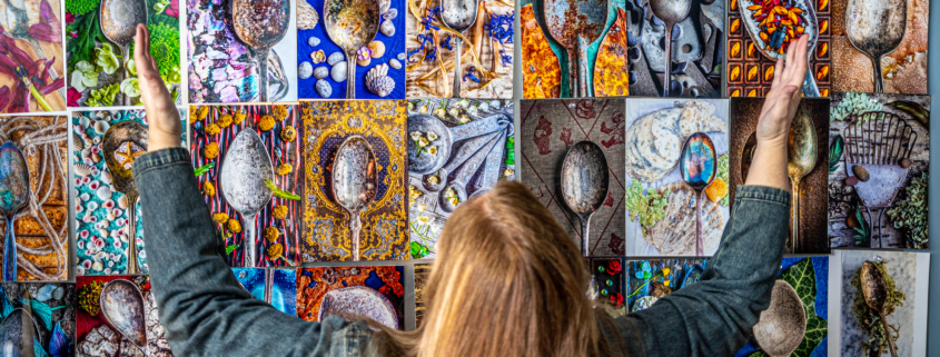 Donna Dufault in front of a wall of her worn spoon photographs